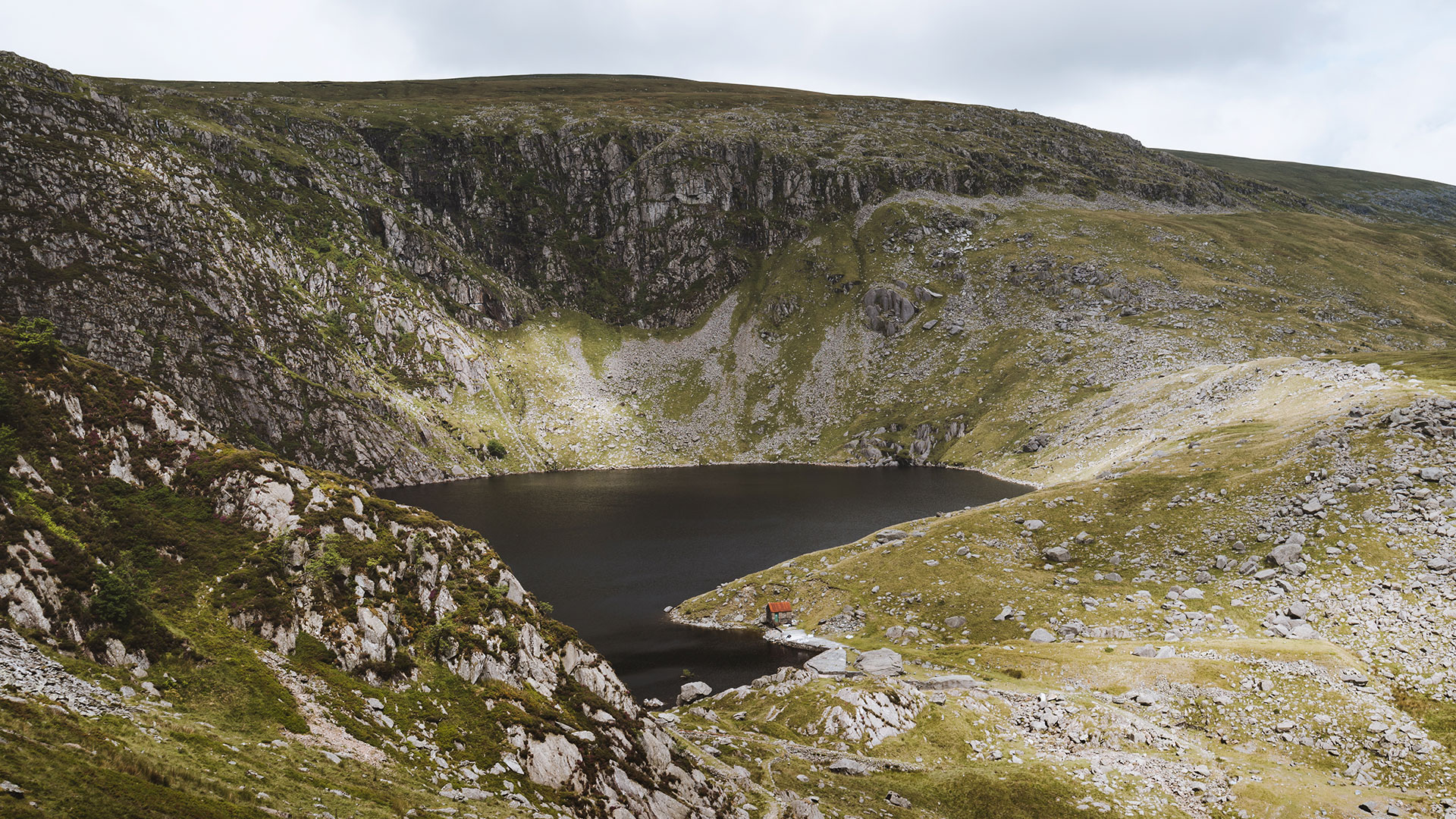 Cliff faces around a small lake in the Carneddau
